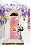 In this quietly enchanting Kilburn doorway scene, every element works together to evoke the excitement and tenderness of moving into a new home. A blush-pink front door, simple and softly painted, stands poised at the centre, its gentle shade hinting at warmth and personality within. The door is framed by whitewashed plaster and a pale shutter, their understated tones giving a sense of calm and order that contrasts with the lively abundance of the flowers around them. Overhead, wisteria cascades in luxuriant drapes of lavender and lilac, each cluster of tiny blossoms forming long, drooping trails that veil the doorframe in a natural curtain. The tumbling vines suggest age and care, the kind of long-tended plant you might discover outside a characterful flat just off the quieter ends of Kilburn High Road or near Brondesbury. On the step at the base of the door, a sturdy grey metal bucket holds an overflowing arrangement of white and cream roses. The blooms are full and rounded, some open wide like soft, ruffled cups, others still coiled in tighter spirals. Bright to muted green foliage threads between the roses, adding depth, texture, and a sense of freshness, as if the bouquet had been arranged only moments before. Around the bucket, a light pink satin ribbon is tied in a graceful bow, echoing the door's colour and adding a touch of ceremony to the arrangement. Soft natural light falls across the scene, creating gentle shadows along the steps and illuminating the petals so they appear almost luminous. The overall mood is one of warm welcome and quiet optimism, perfectly capturing the feeling of a housewarming bouquet delivered by Florist Kilburn to celebrate a new address in this vibrant London neighbourhood.